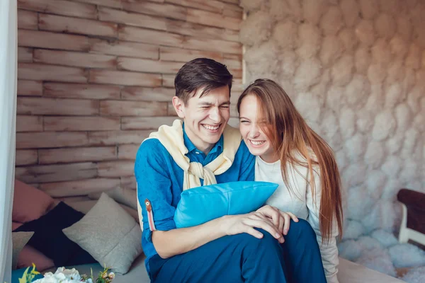 Young couple sitting and having fun at home — Stock Photo, Image