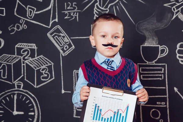 Маленький хлопчик як бізнесмен з вусами показує графік діяльності компаньйонів на темному тлі — стокове фото