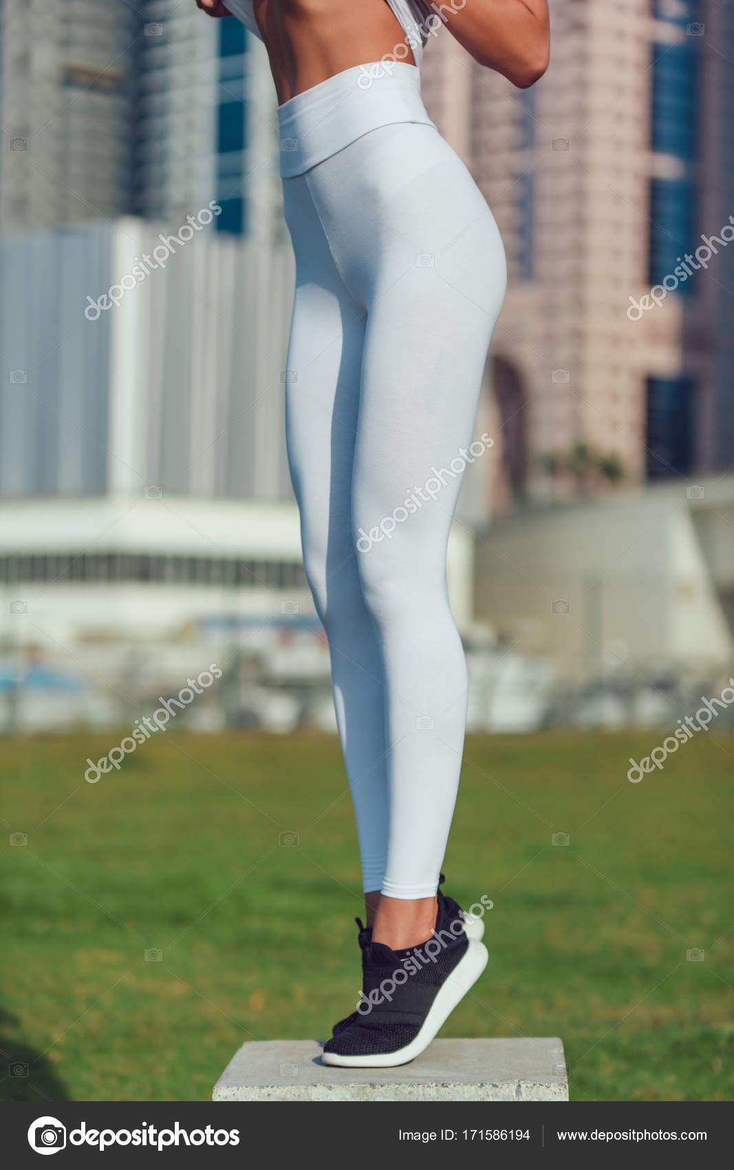 Legs of a sexy girl in white leggings. Mock-up. Outdoor. Stock