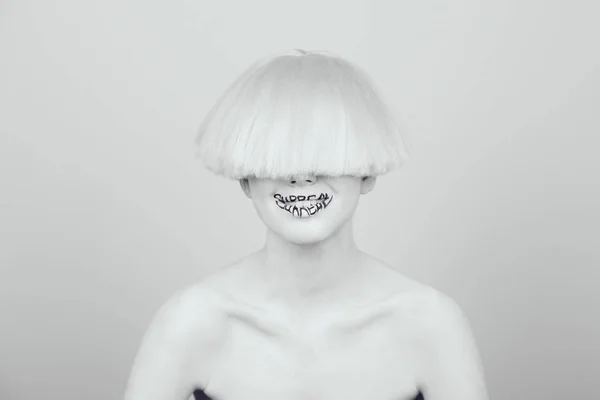 A girl with white skin and a white wig with an inscription on her lips surreal. — Stock Photo, Image