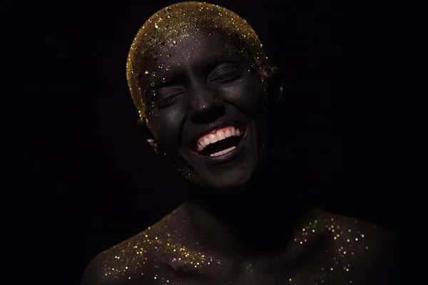 Portrait of a beautiful woman with creative body art glowing make up. Face is colored with black paint. — Stock Photo, Image