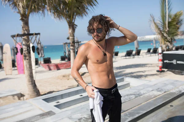 Attractive man with bare chest on the beach.