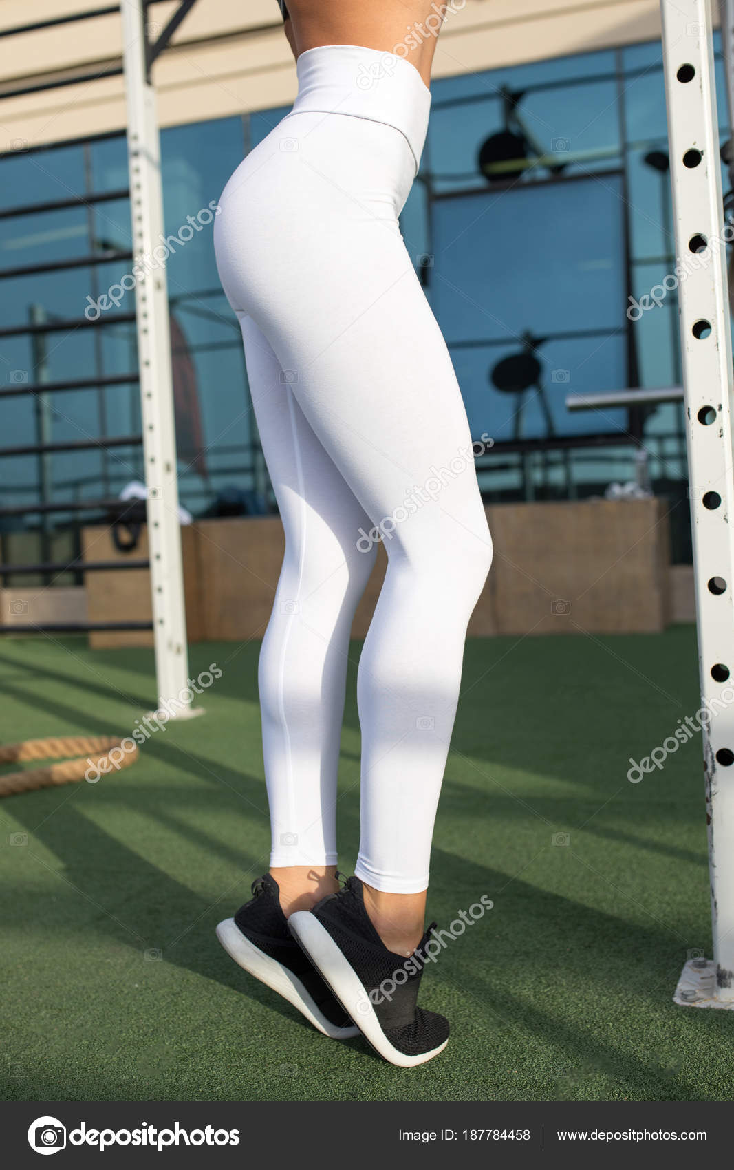 Legs of a sexy girl in white leggings. Mock-up. Outdoor gym. Stock