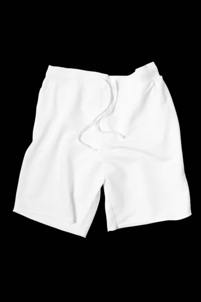 Pantalones cortos blancos sobre un fondo negro recortado. Mock-up . — Foto de Stock