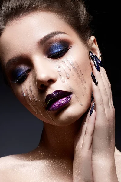 Молодая женщина с творческим макияжем и фиолетовыми губами с градиентом и блестками на лице. Красивая модель с яркими ногтями со стразами . — стоковое фото