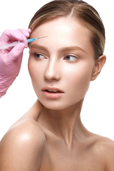 Young girl with a healthy skin and Nude makeup. Beautiful model on cosmetic procedures botox. Stock Picture