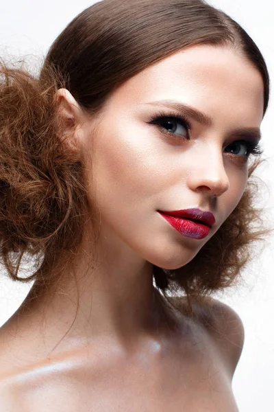 Young girl with creative bright makeup and shining skin. Beautiful model with a hairdo, arrows on eyes and red lips. Beauty of the face — Stock Photo, Image