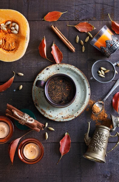 Cup of spiced coffee over dark rustic background