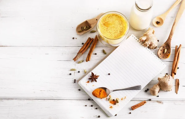 Golden turmeric latte in a glass and spices — Stock Photo, Image