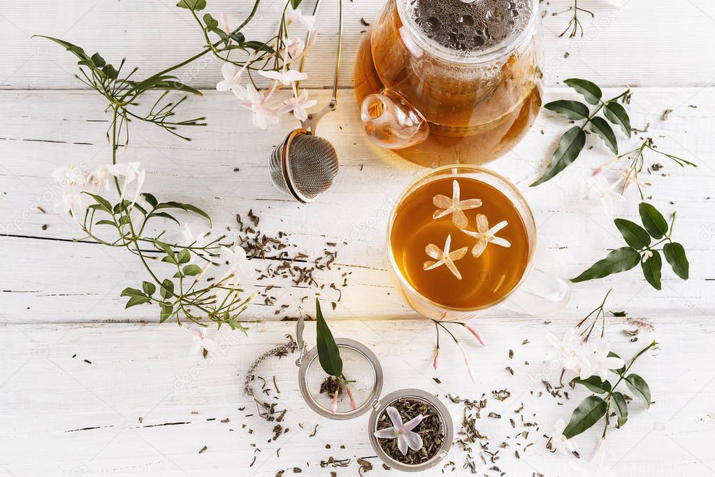 Jasmine tea over white wooden background