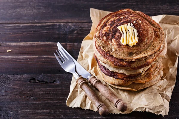 Stack of pancakes over dark rustic background — Stock Photo, Image