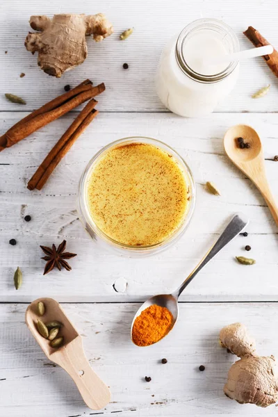 Top view image of turmeric latte over white wooden table Royalty Free Stock Images