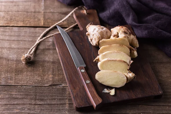 Fresh ginger root on cutting board — Stock Photo, Image