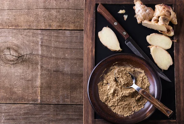 Top view of ground ginger over rustic wooden background Royalty Free Stock Photos