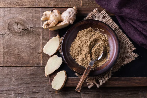 Flat lay of ground ginger over rustic wooden background Stock Picture