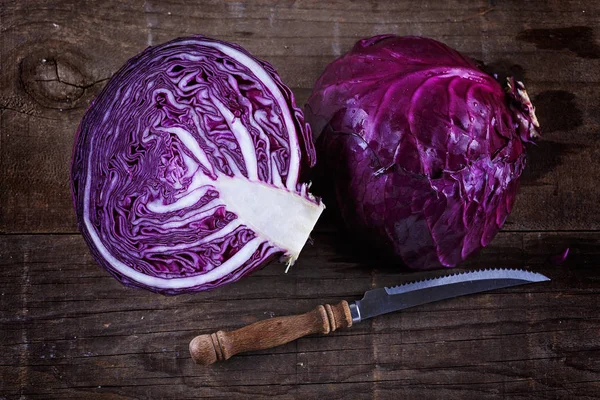 Colorful cabbage cut in half over rustic wooden background — Stock Photo, Image