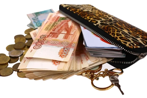 Russian banknotes a pack of money with a face value of 5,000 thousand rubles and 1,000 thousand rubles with coins, drops out of a leopard wallet with a key and discount cards on a white background