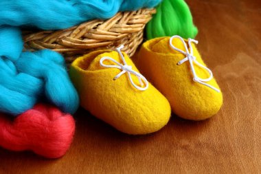Sarı yün bebek paçası ve alpaka yünü, sepet sepetinde ahşap arka planda.. 