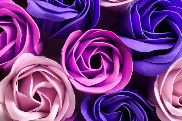 Handmade colorful soap flowers, beautiful pink, violet and purple soap roses, top view