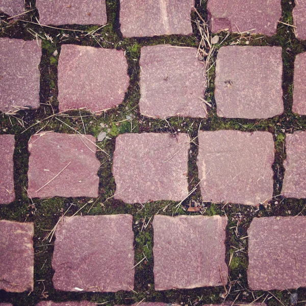 Old pavement with pink colored stones. Close up — Stock Photo, Image