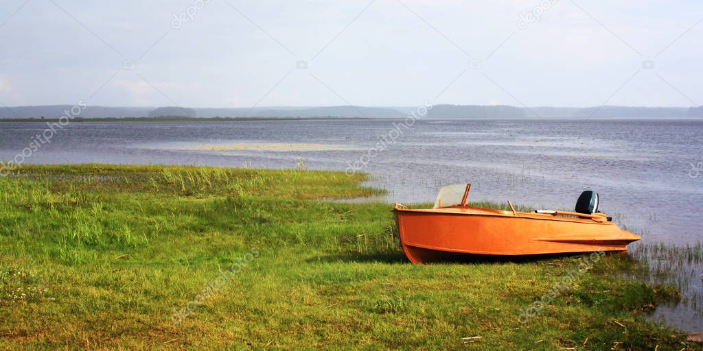 Orange boat at the lakeshore. Russian North.