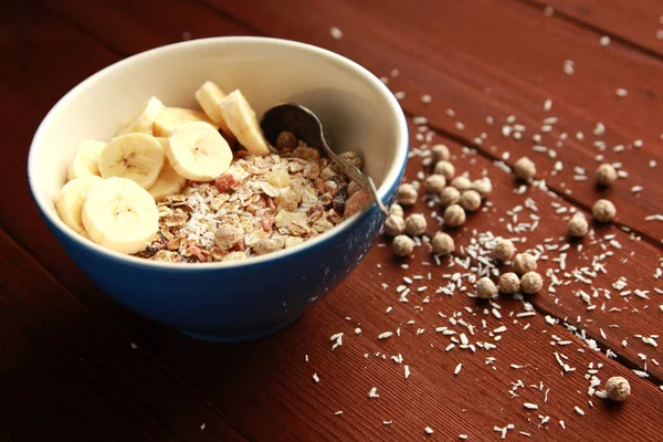 Granola bowl with banana, raisins and nuts closeup