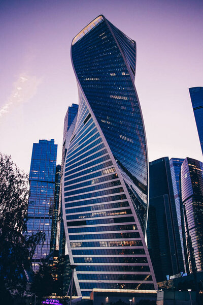 View of the tall skyscrapers. Skyscrapers on a sunset background. High building. Business center of the city. Modern urban architecture. Glass and concrete houses.