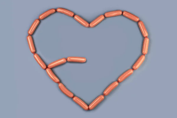 Kiełbaski tworzące serce wyizolowane na szarym tle — Zdjęcie stockowe