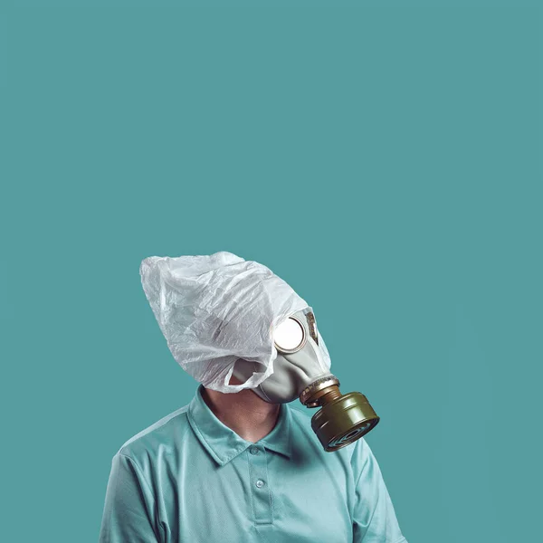 a man in a gas mask and a plastic bag on his head symbolizes the protection of the environment from pollution on a mint background