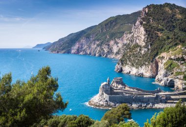 Porto Venere (Portovenere), Liguria, Italy: beautiful aerial scenic view of the Church of St. Peter (Chiesa di San Pietro) from Palmaria Island nearby Cinque Terre with Byron grotto