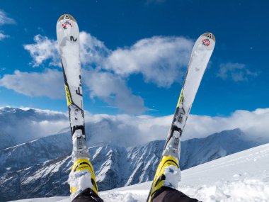 Bardonecchia, Piedmont, Italy - February 2013: Relaxing on snow, relaxation concept, pair of skis, ski and fresh snow, relax, blue sky. Photos with Snow