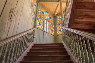 Tbilisi, Georgia - July 2019: Interior of famous traditional old wood Georgian house with colorful stained glass windows and wooden staircase