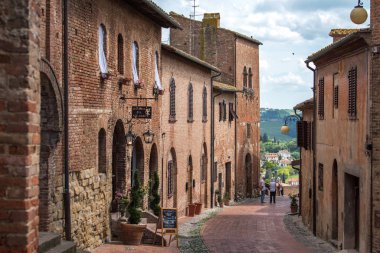 Certaldo, Tuscany, Italy - June 2 2018: People stroll along medieval old town of Certaldo, Boccaccio's hometown in Valdelsa