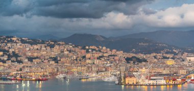 Genova, Genoa, Italy - January 2019: Beautiful aerial view of Genoa port harbor, Magazzini del cotone, Porto Antico, sea and Ferris wheel at dusk from the Lanterna lighthouse. Cityscape photography