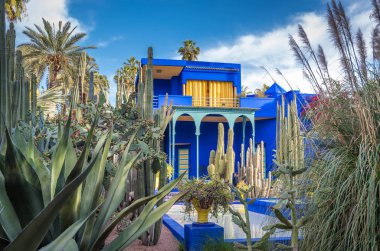 Marrakech, Morocco - April 2019: Beautiful view of Majorelle Garden featuring a Cubist villa designed by Paul Sinoir and purchased by the fashion designers, Yves Saint-Laurent and Pierre Berg