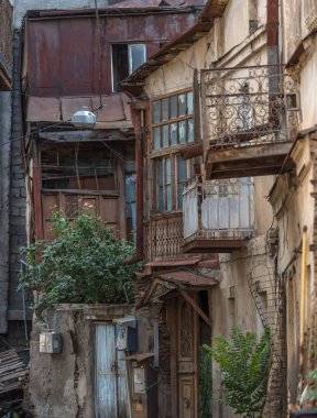 Tbilisi, Georgia - July 2019: typical old Georgian dilapidated shabby houses with wooden balconies in Tbilisi old town