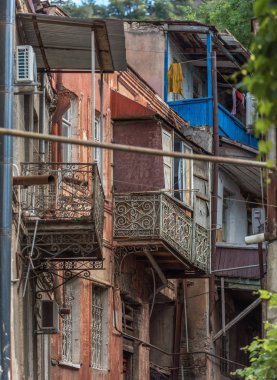 Tbilisi, Georgia - July 2019: typical old Georgian dilapidated shabby houses with wooden balconies in Tbilisi old town