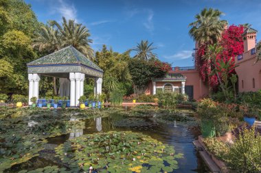 Marrakech, Morocco - April 2019: Pond with water lilies in Majorelle Garden, designed by Paul Sinoir and purchased by fashion designers, Yves Saint-Laurent and Pierre Berg