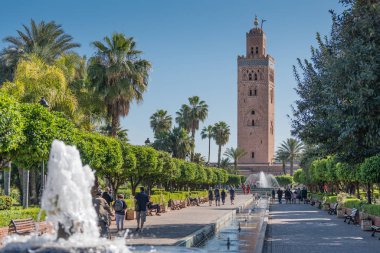 Marrakech, Morocco - April 2019: The minaret of Koutoubia Mosque (also known as Kutubiya and Kutubiyyin) located by the Jemaa El Fna souq (souk) in the medina quarter