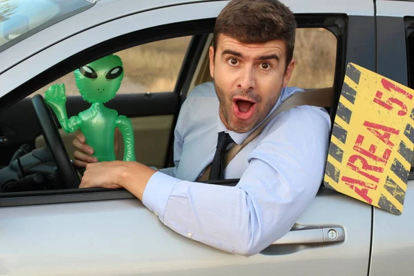 Man Sitting Car Holging Inflatable Alien Toy — 스톡 사진