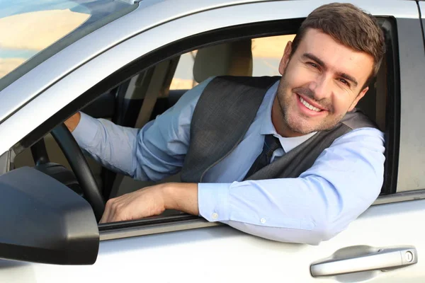 Stock image Smiling businessman driving car