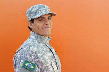 Brazilian army soldier on orange background with copy space clipart