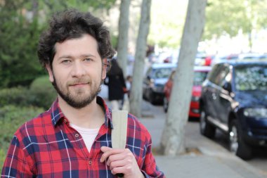 Sokakta şık giyinmiş yakışıklı bir gencin yakın plan portresi.