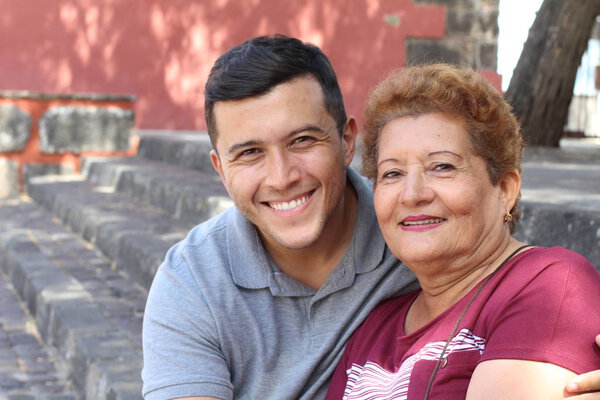 Hispanic senior woman with her son