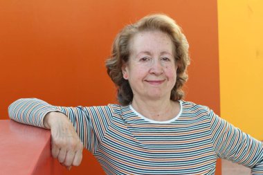 Yüzünde elleri olan yaşlı bir kadının portresi.