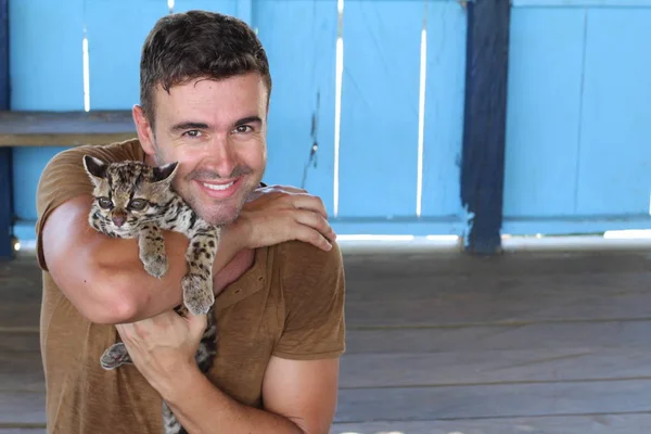 Handsome Man Holding Baby Ocelot — 스톡 사진