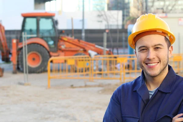 Young Smiling Worker Helmet Standing Folded Hands Construction Background — 스톡 사진