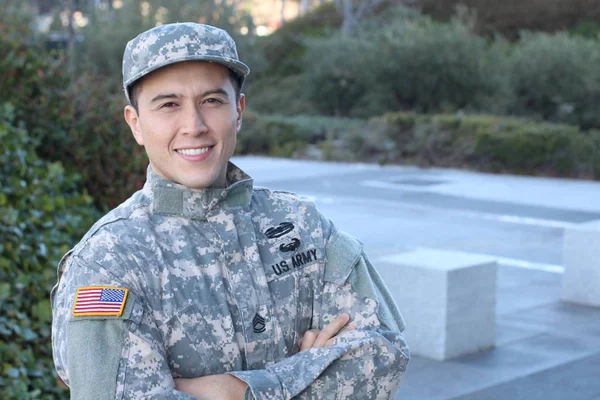 Portrait of young American soldier standing outdoors at daytime