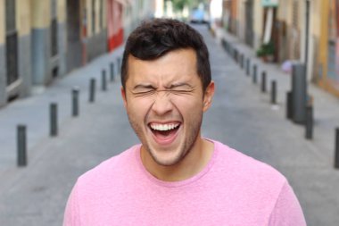 Genç erkek dışarıda çok gülüyor.