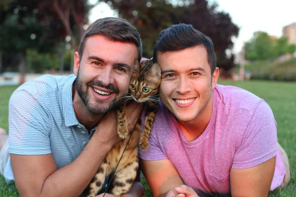 Gay couple in the park with their pet